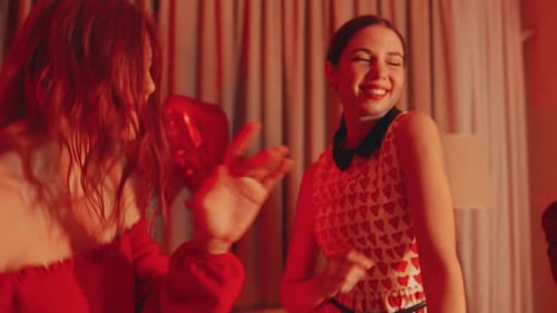 Three Young Women Dancing at Party Indoors