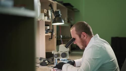 Scientist Using Microscope for Microscopic Analysis
