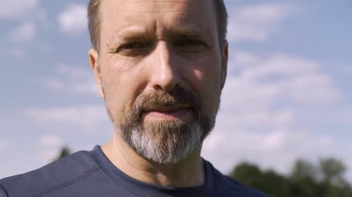 Close Up of Man Smiling Outdoors on Sunny Day