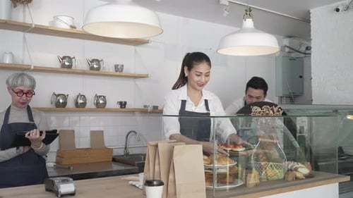 Entrepreneur and team are working at bakery and coffee shop.