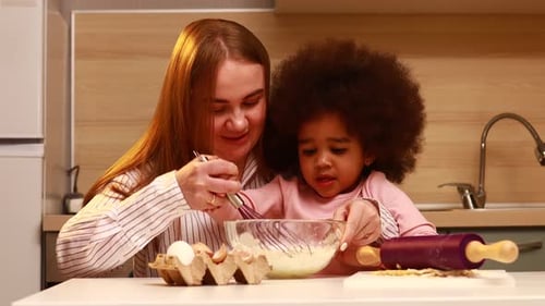 Happy Multiethnic Family Cooking Pastry Together at Kitchen