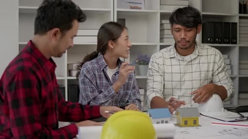 Hands working brainstorming and measuring for cost estimating on architectural and engineering.