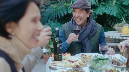 Friends Gather Together for Outdoor Lunch and Wine