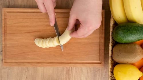 Top View Of Cutting Banana On The Kitchen Table