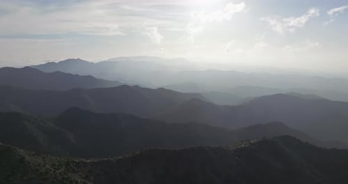 Aerial View of Majestic Mountain Ranges on Sunny Day