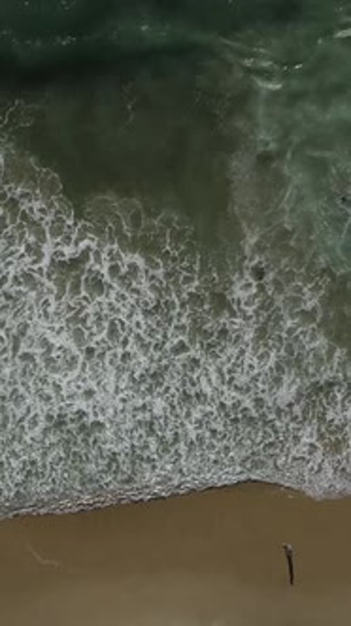 Vertical Video of Ocean Waves Rolling On Shoreline