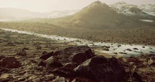 Exploring a Rocky Landscape Under a Hazy Sky with Distant Mountains