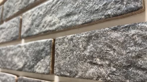 Gray textured brick wall close up shot