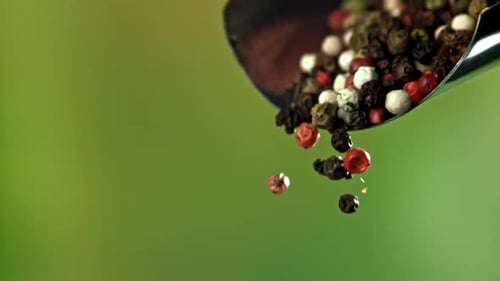 Tri-Color Peppercorns Pouring from a Spoon
