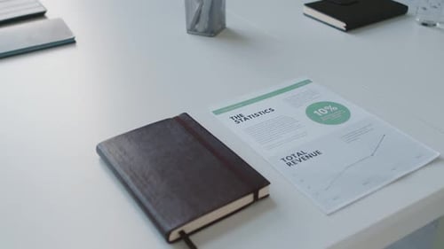 Workplace Desk with Statistics and Rising Revenue Chart