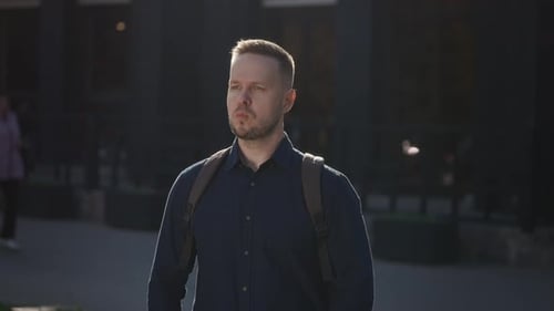 City Street Portrait of a Man in a Shirt and with a Backpack Modern Lifestyle in the City