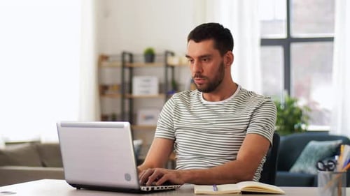 Hispanic man working remotely from home office using laptop for video conference