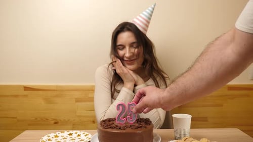 Woman Celebrates Birthday with Cake and Candles