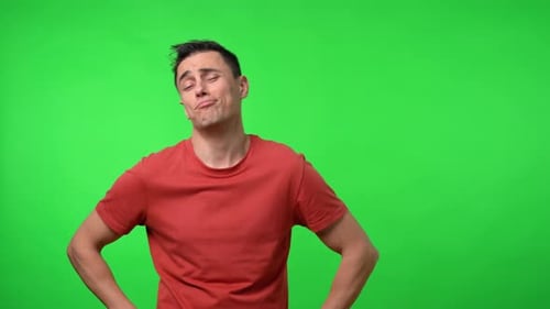 Man Posing Sadly in Front of Green Screen
