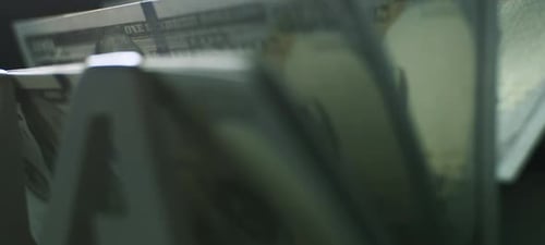 Money Counting Machine Processing Hundred Dollar Bills