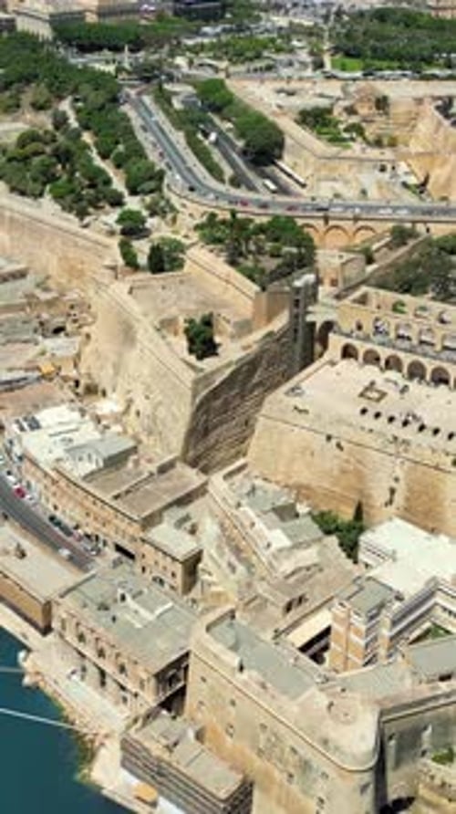 Aerial drone view of the walled city of Valletta, Malta, surrounded by the Mediterranean sea in dayl