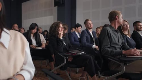 Successful business conference presentation with applauding audience in modern hall