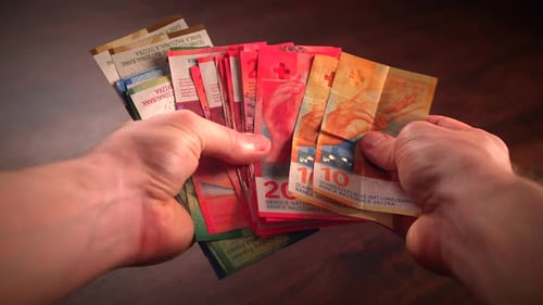 Detailed Closeup of Colorful Swiss Franc Bills Appearing One After Another Switzerland and