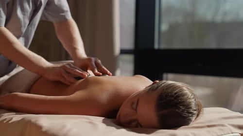 Relaxing Hot Stone Back Massage Therapy in Tranquil Spa Setting with Professional Masseur Soothing