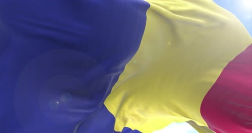 Realistic Romania National Flag Waving in Wind with Sunny Sky