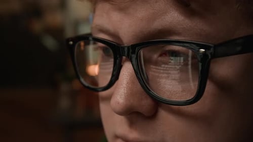 Man Wearing Glasses with Computer Code Reflection Programming on Screen