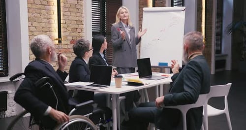 Diverse Team Attends Office Presentation and Discussion