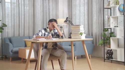 Tired Teenager Having Headache While Learning At Home