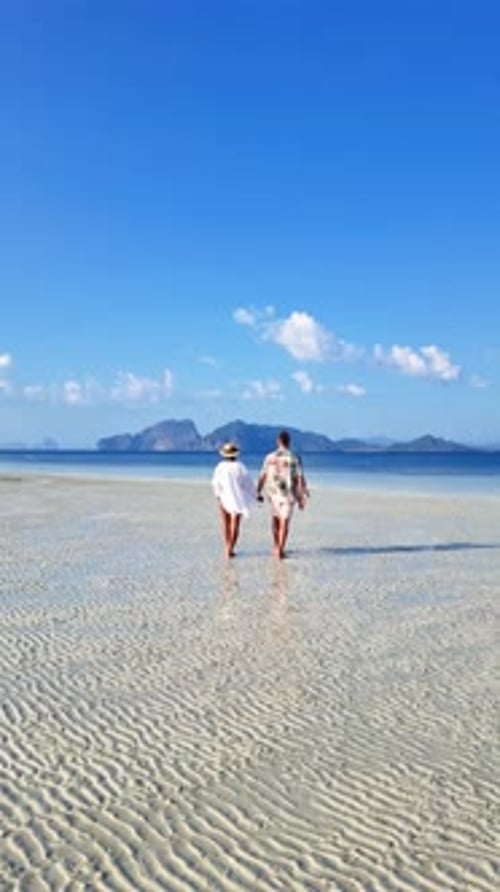 Couple Strolling Along Beach Hand in Hand Under the Vast Sky Koh Kradan Thailand