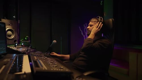Music Production Sound Engineer Working with Recording Equipment in Studio Professional