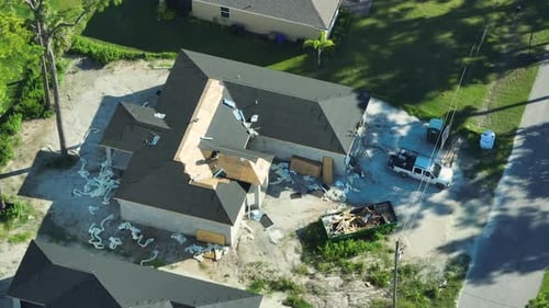 Top View of Professional Workers Installing Bitumen Covering Material on Residential Home Wooden