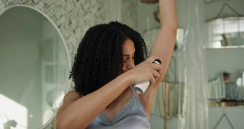 Woman Applies Deodorant in Bathroom Morning Routine