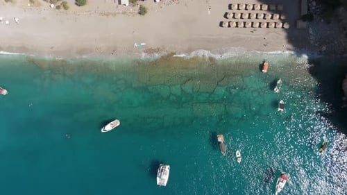 Blue Lagoon aerial drone view beach with several small boats anchored in the water Turkey