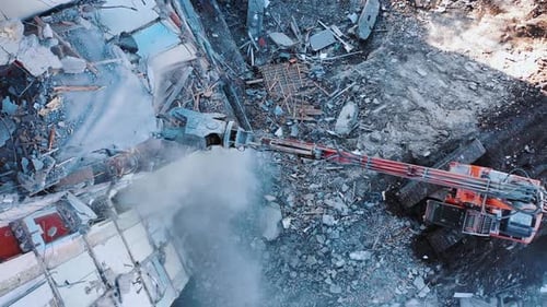 Hydraulic machinery working to get rid of the rubbish in a demolition site.