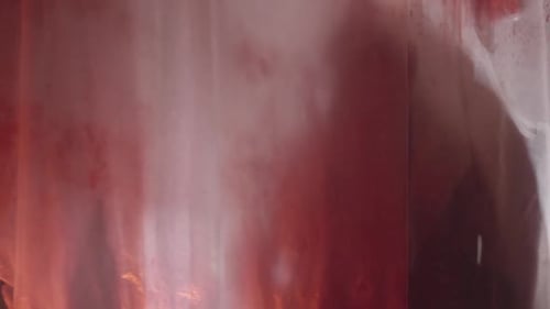 Ominous Figure Behind Red Stained Translucent Material