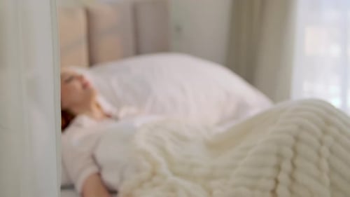 Young Woman Wakes Up in a Bright Bedroom and Begins Getting Out of Bed Morning Routine Healthy