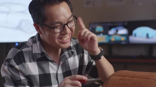 Designer Thinking About New Car Concept Then Raising His Index Finger While Working On Car Clay