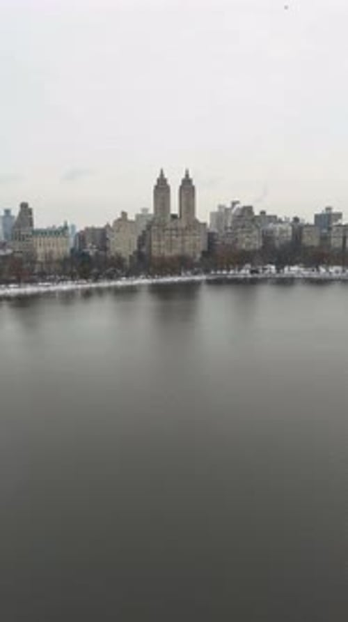Serene winter view of Central Park lake with Manhattan skyline, New York, USA
