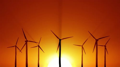 Silhouetted Wind Turbines at Sunset