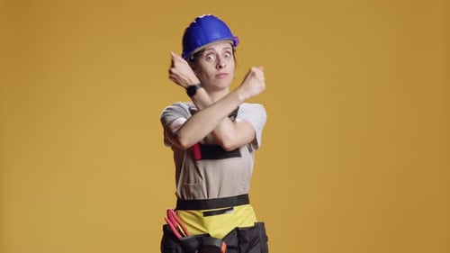 Portrait of Strong Handywoman Doing x Shape Sign with Arms Crossed
