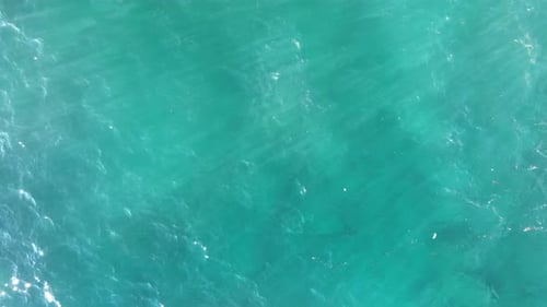 Aerial Footage of Turquoise Ocean Waters Washing Rugged Rocky Shoreline