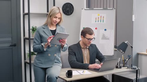 Business Professionals Collaborate on Project in Modern Office