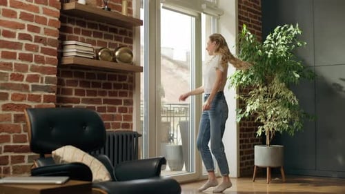 Woman with Blonde Hair Dances Joyfully Indoors