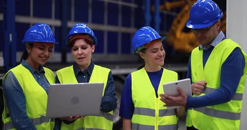 Multiethnic Engineers Working Inside Robotic Factory - Industrial and Technology Concept African