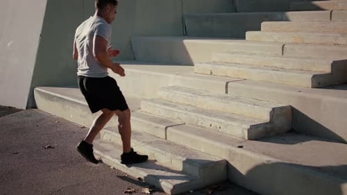 Man Running Up Concrete Steps Outdoors