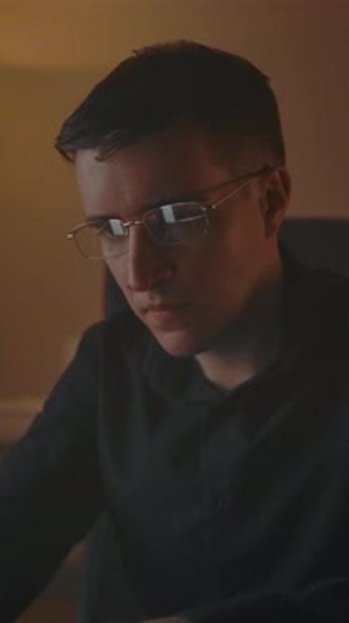 Man Working at Computer Massages Temples