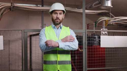 Confident Engineer with Safety Gear in Electrical Substation Technical Room