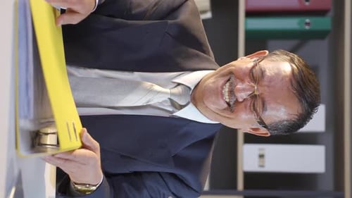 Adult Reacting to Paperwork in Office Vertical Format