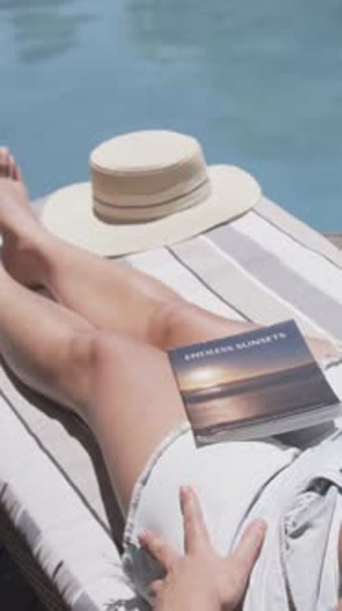 Vertical video: Filming woman in bikini adjusting right hand on lap at pool, ENDLESS SUNSETS book