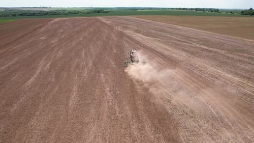Aerial view of tractor tilling field, Bulgaria.
