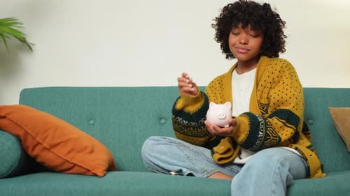 Saving Money Investment for Future African American Girl Holding Pink Piggy Bank and Putting Money